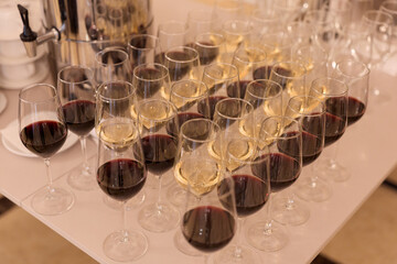 Sophisticated Arrangement Of Crimson Wine Glasses On Pristine Table At Luxury Hotel Reception
