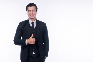 Professional handsome businessman showing thumbs up gesture on white background. Happy male entrepreneur in black suit recommending best product or agreeing with smile.