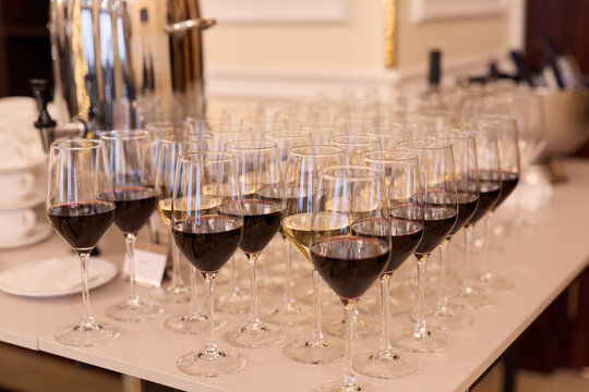 Sophisticated Service Area With Pristine Stemware And Bustling Staff Preparing For Celebration