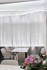 Bright Cafe Setting, Sundrenched Restaurant Corner Featuring Fresh Flower Arrangements And Welcoming Ambiance