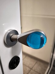 Modern door handle with blue transparent ball