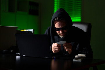 Crypto currency hacking. Hacking hunting for crypto currency. Cryptocurrency hack. Hacker in hoodie dark night theme. Digital data security concept. Hackers attack. Cybersecurity, Internet crime.
