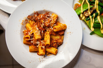 Italian food rigatoni pomodoro close up overview