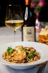 fish and peas dish close up and glass of white wine