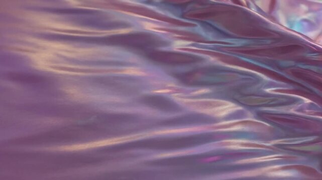 An mesmerizing abstract background featuring a luxurious, iridescent surface in rich shades of lavender and purple. The smooth, liquid-like material gently undulates and flows, creating soft, dynamic 