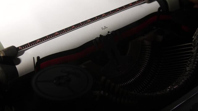 Vintage typewriter making a postscript on a piece of white paper, showing the metal ruler and type bars with light highlighting the letter p.S. For a nostalgic impression