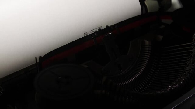 Typewriter ribbon imprinting the first words on blank paper, close up vintage scene evoking the start of a new chapter, creative project, or literary idea in progress