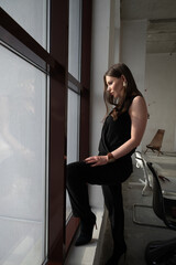Woman Standing by Window in Natural Light Interior