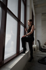 Woman Standing by Window in Natural Light Interior