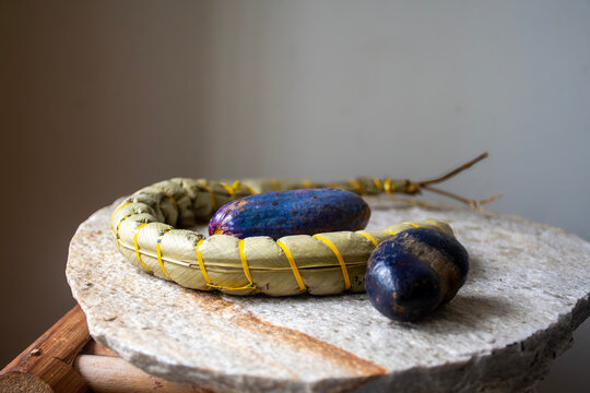 Traditional Cameroonian cuisine: cassava sticks wrapped in their natural leaves meet African plums (safous) here,