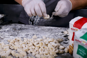 chef preparing gnocchi by hand in the traditional way