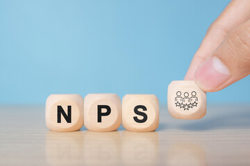 Net Promoter Score (NPS) measuring customer satisfaction and loyalty concept.Tool for measure customer loyalty and improvement products or services. Wooden cube blocks with NPS text and icon.