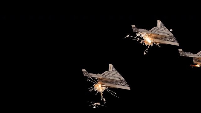 Flying US dollar paper airplanes with sparkler rockets and clear alpha channel background.