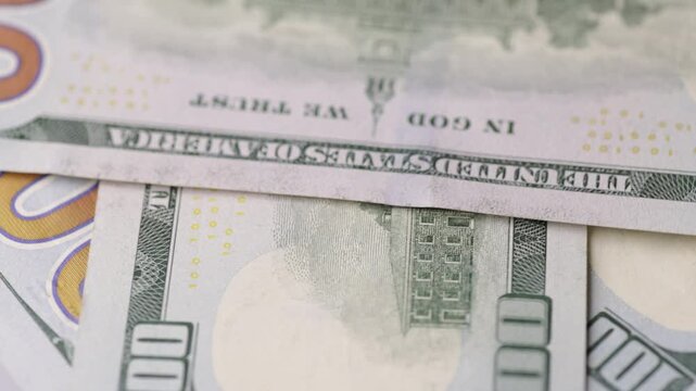 Back side of one hundred dollar banknotes rotating in detailed macro scene seamless loop