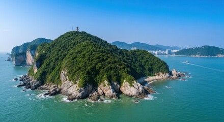 Obraz premium Panoramic view of a verdant island, rocky coastline, and clear waters. A tall structure atop the island's highest point is visible