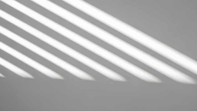 Shadows cast by parallel bars on a gray surface from an overhead viewpoint