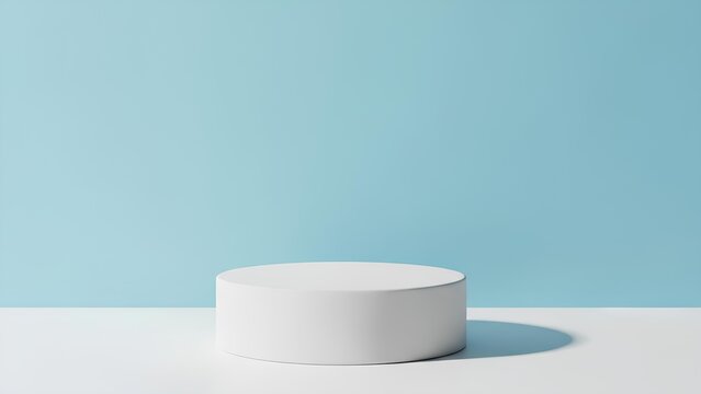 A white circular pedestal stands alone on a white surface against a light blue background