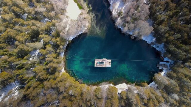 Top down view of naturral wonder Kitch-iti-kipi hot Springs in Michigan upper peninsula during winter time.