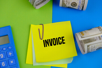 calculators, banknotes, pens and colored paper with the word accounting invoice