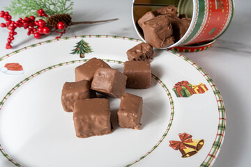 Closeup of small Brazilian honey cakes on a plate with Christmas decorations.