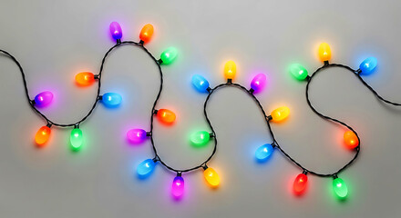 String of colorful oval L E D lights on black wire against gray background image