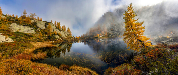 Autumn mountain lake in fog