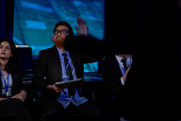 A diverse team with an Indian man, Indian woman, and Caucasian man in a security awareness briefing. They are sitting and listening, learning about online safety, data protection.