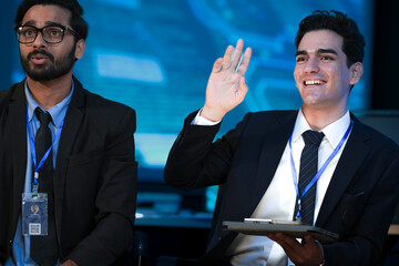 A diverse tech team discusses a new digital strategy. An Indian manager uses a tablet to show AI driven analytics for sustainable ESG growth to a colleague.