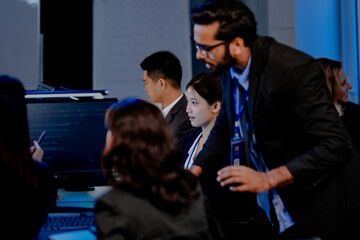 A strategy team reviews predictive analytics generated by an AI platform. The lead points to a forecast, guiding the team in making a critical, data-driven business decision.