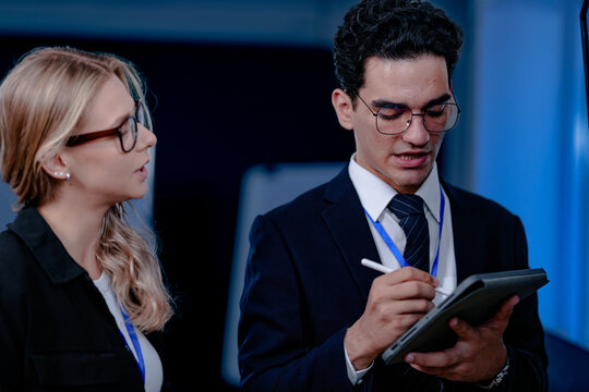 Unveiling the future. Smiling innovator presents a groundbreaking algorithm or quantum code on screen, explaining the next leap in AI or complex computation to his excited team.
