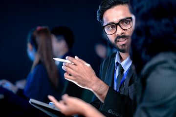 Future AI strategy talk. Male visionary leader explains ethical AI implementation or market disruption plan to female strategist surrounded by futuristic data screens.
