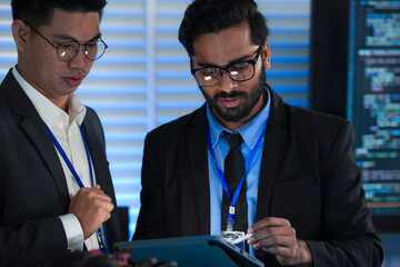 Lead developers analyze system architecture late night using tablet stylus pointing out details...