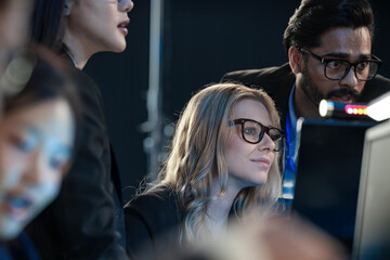 High stakes finance night Diverse analysts track volatile global markets intense focus monitor screens real time data critical decisions hedge fund trading floor pressure on now.