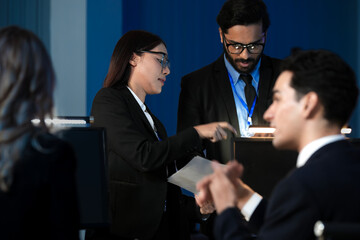 Data integrity check night shift Diverse team meticulously audits financial performance comparing figures tablet screen printed reports ensuring accuracy crucial validation process underway hub.