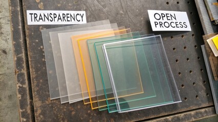 Transparent Sheets Arranged with Labels for Transparency and Open Process on a Rustic Workbench Surface