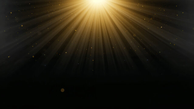 Golden light rays shining brightly in dark space with sparkling particles