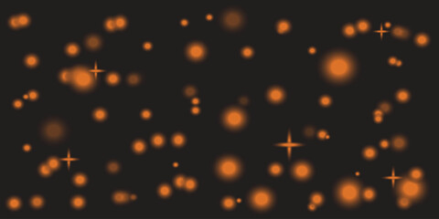 Blurry orange lights on a dark background with star like effects