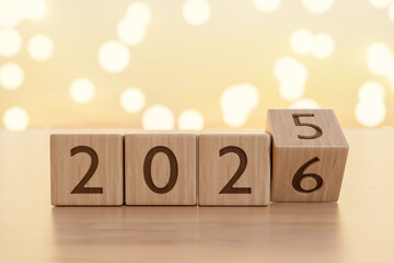 2026 new year countdown wooden blocks calendar on counter table in warm light and blurred background