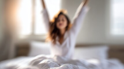 Woman stretching arms overhead with morning sunlight entering bedroom