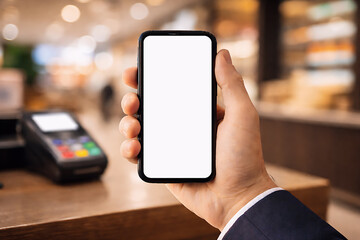 Ecommerce Online Payment App Concept &ndash; Hand Holding Smartphone With Blank Screen at Checkout Counter