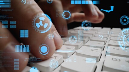This image captures hands actively typing on a keyboard, enhanced by futuristic digital data visualizations, symbolizing technology and information in a modern workspace. Xenic