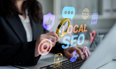 A businesswoman analyzes local SEO strategies using a magnifying glass in a modern workspace filled with technology elements, showcasing digital marketing insights and growth potential. Gantry