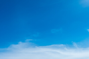 Fototapeta premium A bright, clear blue sky meets a glowing white horizon, suggesting a serene, open, and with sunlight of beautiful cloudy sky. landscape or abstract background. 