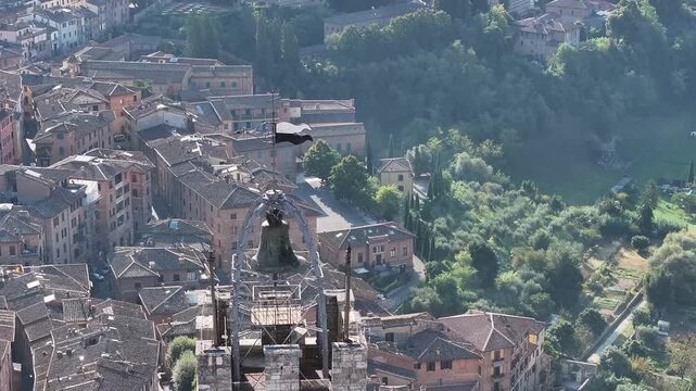 Drone shot overlooking the historic city of Siena in Tuscany, Italy, featuring the bell tower and surrounding medieval architecture.