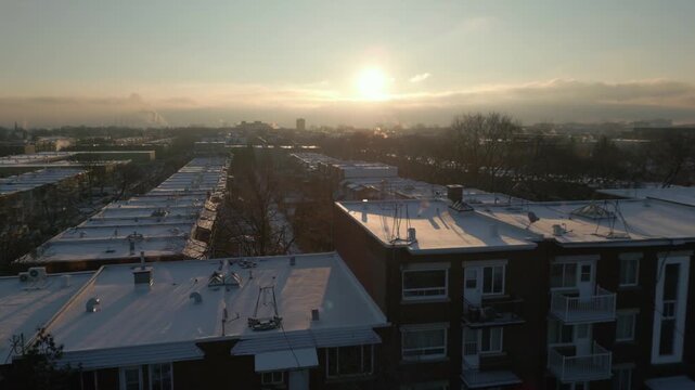 Winter cityscape of Vieux Rosemont with Olympic Stadium visible on horizon at soft sunset light, panoramic establishing Montreal Canada