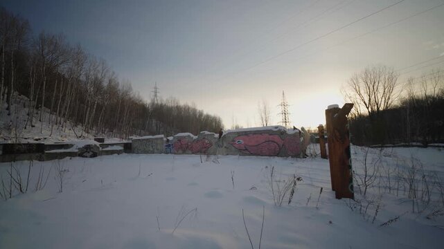 Belgo Factory, Shawinigan, Quebec, Canada abandoned industrial site in winter with snow ground, graffiti walls and slow push in movement.