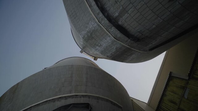 Belgo Factory abandoned concrete silos in Shawinigan Quebec Canada seen from low angle, massive industrial structures, weathered surfaces and urban exploration architecture