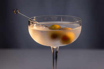 Beautiful and refreshing Martini with two olives with play in the highlights and shadows and color temperatures.