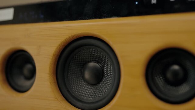 Close-up of a bamboo speaker vibrating and playing music. The speaker has a sleek, modern design and is made of sustainable materials. music enjoyment, or relaxation.