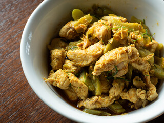 Thai stir fried chicken and bitter gourd with yellow curry